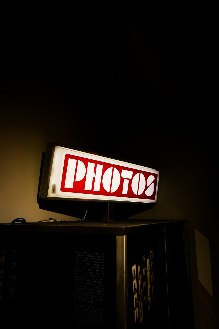 The photobooth set up at an event, with a warm tan curtain and vintage styling
